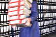 Worker in working clothes, carrying  red folders