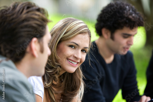 group of friends outdoors in a park smiling group of friends outdoors in a park smiling