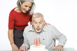 Senior man blowing candles