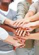 Team with hands stacked in unison