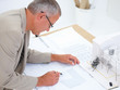 Top view of architect working on a plan