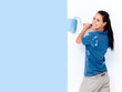 Woman painting a wall with a roller