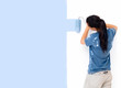 Back side view of a lady painting a wall