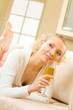 Portrait of young beautiful woman with champagne glass, indoors