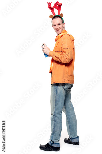 Photo: Young man wearing reindeer horns, holding a can of spray Young man wearing reindeer horns, holding a can of spray