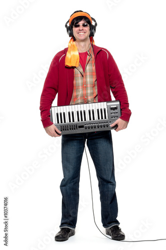 Photo: Casual young man holding an electronic musical keyboard Casual young man holding an electronic musical keyboard
