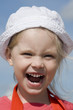 Shouting little girl on the sea coast