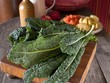 Lacinato kale on a wooden cutting board Lacinato kale on a wooden cutting board