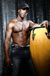 Portrait of young latino percusionist playing african drums