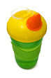 Plastic sippy cup, green with yellow cover, isolated on white
