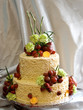 Beautiful two tiered cake with fresh fruit and flowers Beautiful two tiered cake with fresh fruit and flowers
