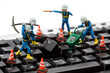 computer repair concept - workers repairing keyboard