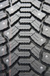 Background of black winter tyre with thorns