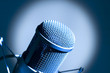 Microphone in studio. Dark blue light.