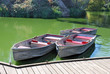 Photo: Three boats docked on a lake on a sunny day Three boats docked on a lake on a sunny day