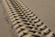 close up of tire tracks in sand