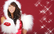 Attracive girl in santa cloth blowing snow from hands.