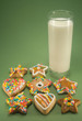 Christmas cookies and a glass of milk isolated on green paper