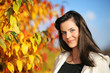 Beautiful young woman in autumn park. Shallow DOF.