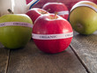 Red & green organic apples on a rustic wooden table Red & green organic apples on a rustic wooden table