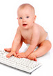 Baby playing with a keyboard. Isolated over white background.