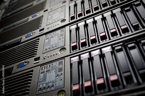 Photo: Servers stack with hard drives in a datacenter rack Servers stack with hard drives in a datacenter rack