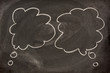 two blank speech bubbles or callouts sketched on blackboard
