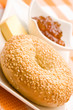 Fresh bagel with jam and butter on a plate