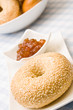 Fresh bagel with jam on a plate