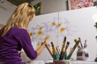 A female artist painting on canvas in her studio