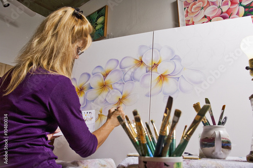 A female artist painting on canvas in her studio