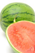 Close up of fresh watermelon halved over white