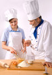 Portrait of happy male und female chefs