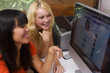 two teenage girls websurfing on their computer