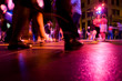 Dance floor with people dancing under the colorful lights