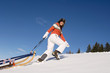 Woman in mountains with sledge
