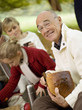 Photo: Germany, Baden-Württemberg, Swabian mountains, Three generation family having picnic in forest Germany, Baden-Württemberg, Swabian mountains, Three generation family having picnic in forest