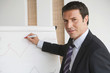 Business man writing on flipchart