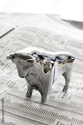 Photo: Bull figurine on journal, close-up Bull figurine on journal, close-up