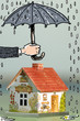 Hand holding umbrella above house, close-up