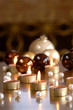 Christmas baubles and burning tea lights