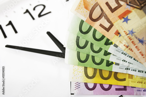 Foto: Euro notes and clock, symbol for time is money Euro notes and clock, symbol for time is money