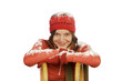 Young woman leaning on sledge, smiling, portrait