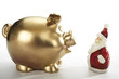 Golden piggy bank and santa claus figurine