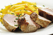 Roasted pork with rutabaga vegetables on plate, close-up