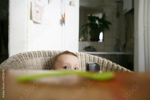 Photo: Baby boy (12-18 months) sitting on chair, portrait Baby boy (12-18 months) sitting on chair, portrait