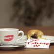 Cup of coffee with lipstick kiss, croissant and I love you-sign