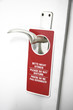 Please do not disturb sign on door handle, close-up