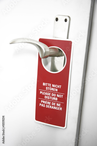Photo: Please do not disturb sign on door handle, close-up Please do not disturb sign on door handle, close-up