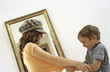 Boy and girl struggling in front of mirror